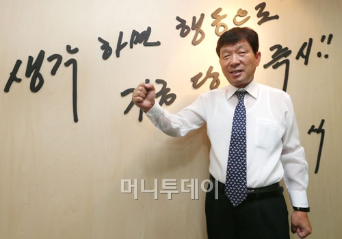 ↑"생각하면 행동으로, 지금 당장 즉시!"라고 쓰여진 벽 앞에 서 있는 김 회장. ⓒ홍봉진 기자