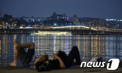 전국적으로 열대야가 이어지고 있는 24일 밤 서울 반포대교에서 시민들이 한강을 보며 더위를 식히고 있다. 기상청은 당분간 낮에는 폭염, 밤에는 열대야가 기승을 부릴 것으로 전망했다. /뉴스1 DB