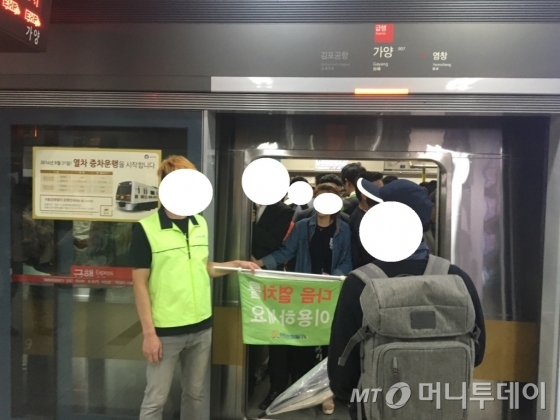 지하철 9호선 가양역에서 한 안내요원이 승객들이 추가로 탑승하지 못하게 안내하고 있다./사진=남형도 기자