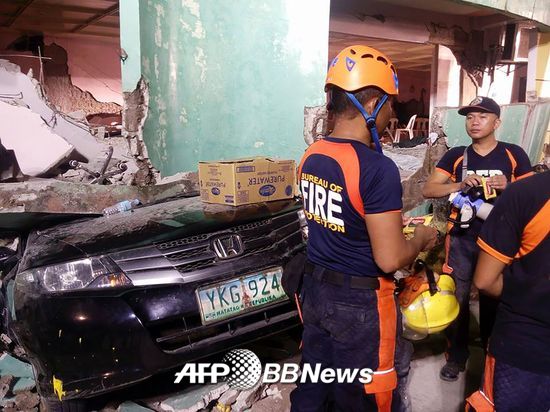 필리핀에서 발생한 지진으로 붕괴된 건물과 차량 /사진=AFP