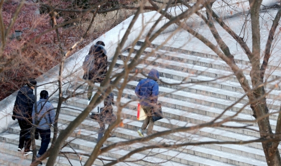 매서운 한파가 이어진 지난해 12월6일 오전 서울 관악구 서울대학교에서 몸을 잔뜩 움크린 학생들이 앙상하게 남은 나뭇가지가 있는 교정을 지나고 있다./사진=뉴시스<br>
