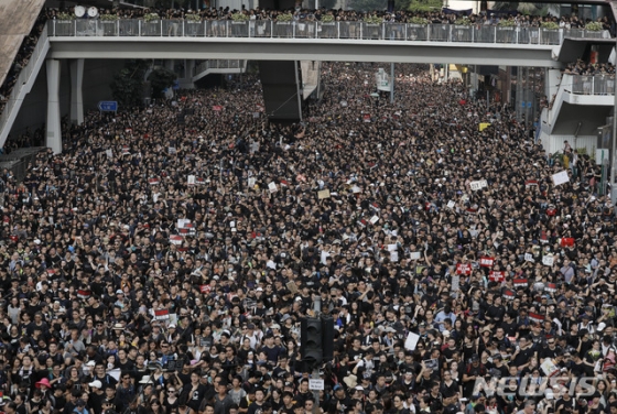 【홍콩=AP/뉴시스】홍콩에서 범죄인 인도법 철회를 요구하는 항의 시위가 연일 계속되고 있는 가운데 100만명이 넘는 홍콩 시민들이 16일 홍콩 시내에서 거리 행진을 벌이고 있다./사진=뉴시스