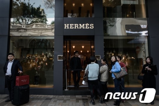 2014년1월 20일(현지시간) 관광객들이 홍콩에 위치한 명품 매장에 들어가기 위해 줄을 서고 있다. /AFP=뉴스1