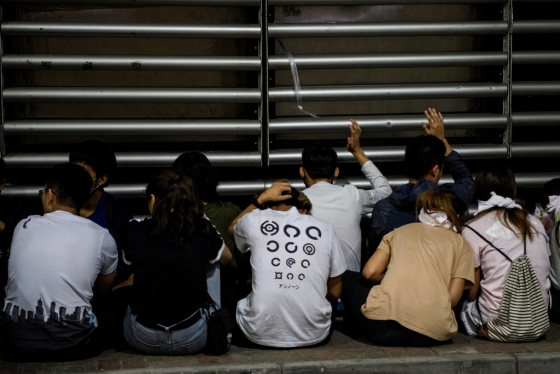 19일 홍콩 이공대 앞에서 경찰에 의해 진압된 학생들이 벽을 보고 앉아 있다/사진=AFP