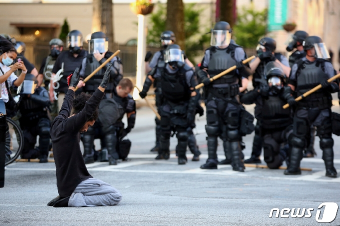 미국 조지아주 애틀랜타에서 한 시위자가 진압 경찰 앞에서 무릎을 꿇고 있다. <기사 내용은 사진과 무관> © 로이터=뉴스1