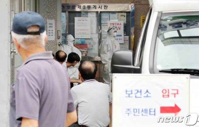 (서울=뉴스1) 이성철 기자 = 10여명의 무더기 신종 코로나바이러스 감염증(코로나19) 확진자가 도봉구 성심데이케어센터에서 발생한 가운데 12일 서울 도봉구보건소에서 시민들이 검체 검사를 받기 위해 기다리고 있다. 도봉구청 관계자는 해당 센터에 있는 어르신들 40여 명과 직원 23명 등 모두 60여 명에 대한 전수검사를 진행해 확진자 14명을 파악했다고 밝혔다. 2020.6.12/뉴스1