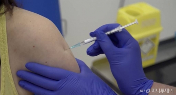 [옥스퍼드=AP/뉴시스]23일(현지시간) 영국 옥스퍼드의 옥스퍼드 대학교에서 한 임상시험 자원자가 신종 코로나바이러스 감염증(코로나19) 시험용 백신을 맞고 있다. 옥스퍼드대학 연구진은 이날 코로나19 백신 임상시험 자원자 800여 명 중 2명에게 처음으로 투약했다. 2020.04.24.