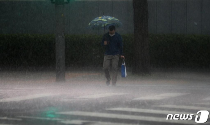 (서울=뉴스1) 황기선 기자 = 비가 내리는 18일 오후 서울 종로구 정부서울청사 앞에서 우산을 쓴 시민들이 걸음을 재촉하고 있다. 2020.5.18/뉴스1