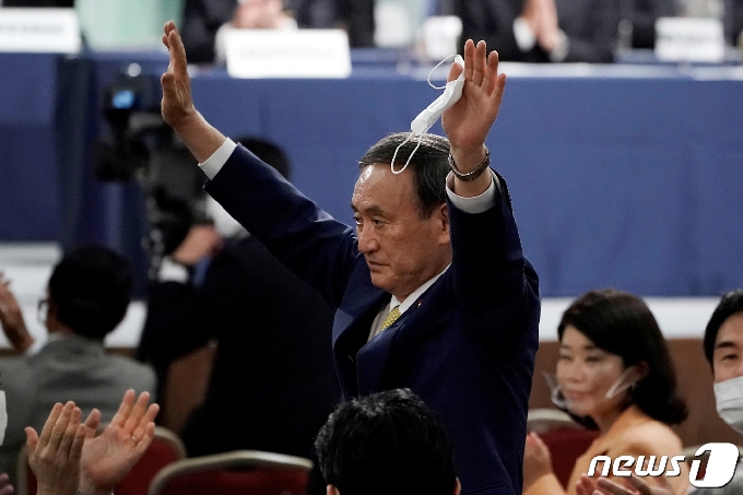 일본 집권 자민당의 스가 요시히데 신임 총재가 14일 치러진 당 총재 경선에서 승리한 뒤 소속 국회의원들을 향해 손을 흔들고 있다. © 로이터=뉴스1