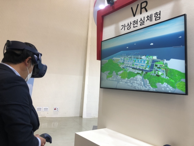 28일 서울 동대문 디자인플라자(DDP)에서 열린 '2020 그린뉴딜 엑스포' 한국동서발전 전시관에서 한 시민이 VR(가상현실) 기기를 체험하고 있다. /사진=강민수 기자
