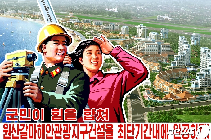 2018년 원산 갈마해안지구의 건설조감도를 배경으로 만든 북한의 선전포스터. 원래 2019년 완공 계획이었으나 여러 차례 완공이 미뤄져 아직까지 준공식을 하지 못하고 있다. (평화경제연구소 제공) 2020.12.19.© 뉴스1