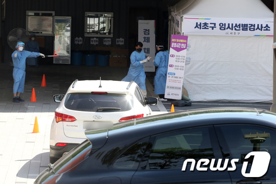 지난 21일 오후 서울 서초구 서초종합체육관에 마련된 신종 코로나 바이러스 감염증(코로나19) 드라이브스루 방식 임시 선별검사소에서 차량에 탄 시민이 검사를 기다리고 있다./사진=뉴스1