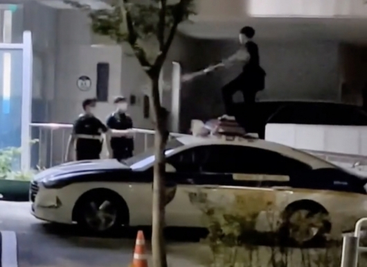 한 소년이 긴 막대를 들고 서울 강동경찰서 고덕파출소 앞에서 난동을 부리는 영상이 지난 12일 공개됐다./사진=온라인 커뮤니티