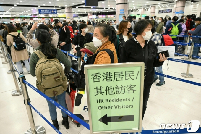 1월 8일(현지시간) 중국의 코로나19 방역 조치인 입국자 격리가 폐지된 첫 날 중국의 육로 접경 검문소인 홍콩 록마차우 검문소에 중국으로 가려는 주민들이 줄을 서 있다.  /AFPBBNews=뉴스1