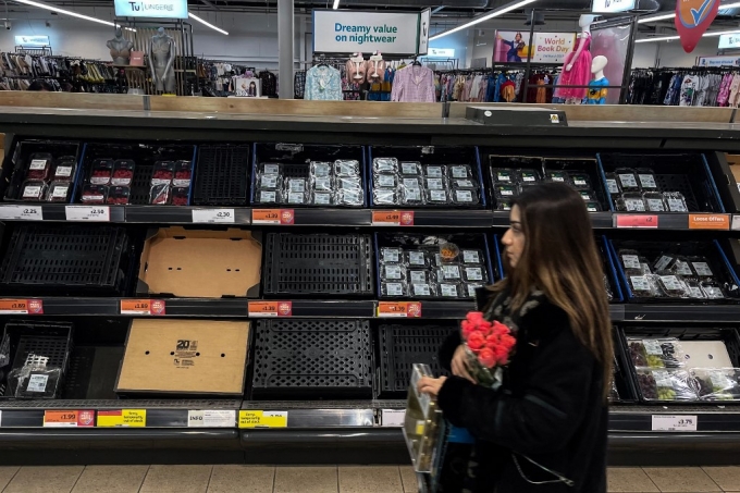 24일(현지시간) 영국 런던에 있는 한 세인스버리 슈퍼마켓에서 소비자가 텅 빈 채소 매대 옆을 지나가고 있다./AFPBBNews=뉴스1