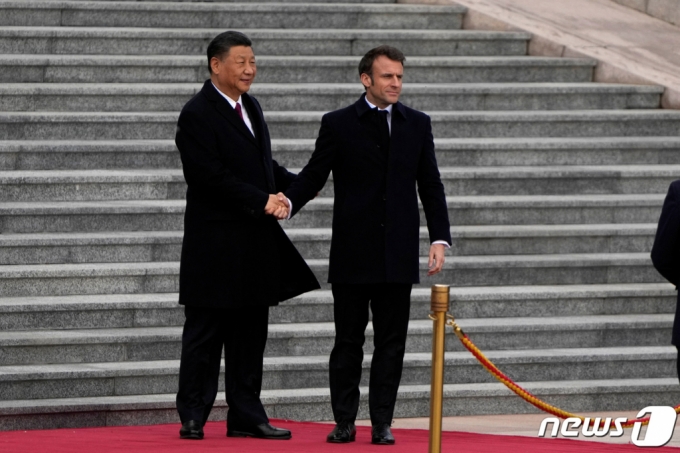 에마뉘엘 마크롱 프랑스 대통령(오른쪽)이 6일 중국 베이징 인민대회당에서 열린 환영식서 시진핑 중국 국가 주석과 악수를 하고 있다.  /로이터=뉴스1