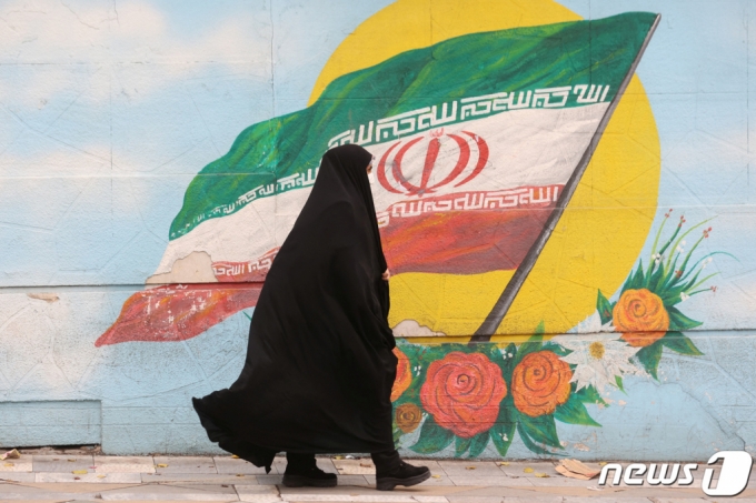 지난해 12월6일(현지시간) 이란 테헤란에서 한 여성이 히잡을 입고 거리를 걷고 있다. / 로이터=뉴스1