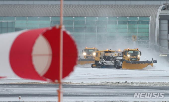 올해 들어 가장 추운 날씨를 보이는 23일 오전 폭설로 인해 운항이 중단된 제주국제공항 활주로에서 제설차가 쌓인 눈을 치우고 있다. /사진=뉴시스