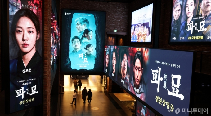  영화 '파묘'가 주말 하루에만 55만명이 관람하며 파죽지세 행보를 보이고 있다. 10일 서울의 한 영화관에 ‘파묘’ 홍보물 앞으로 시민들이 지나가고 있다.  /사진=뉴스1