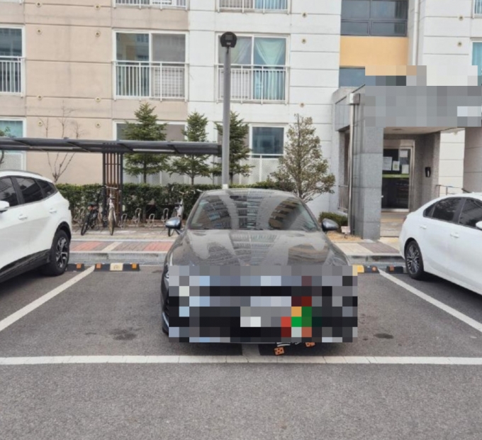 아파트 단지 내에서 주차 2칸을 모두 차지한 한 차량이 공개돼 누리꾼들 사이에 공분이 일고 있다./사진=온라인 커뮤니티 캡쳐