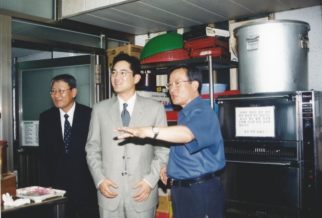 2003년 6월 이재용 삼성전자 회장(당시 상무·가운데)이 서울 영등포 요셉의원을 방문해 고(故) 선우경식 원장(오른쪽)의 안내를 받으며 시설을 둘러보고 있다./사진=위즈덤하우스 제공,뉴스1